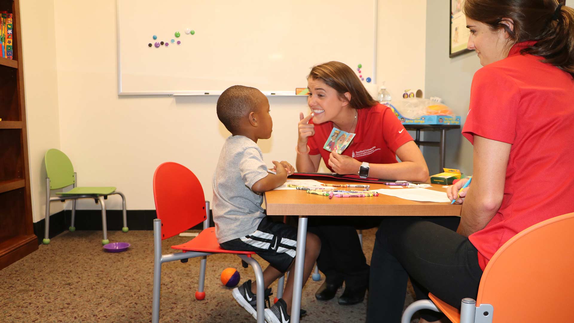 speech therapist working with young boy