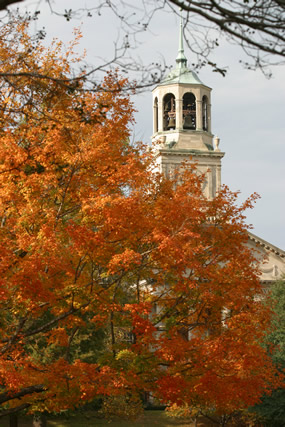 The belltower of the Harwell G. Davis Library Building amid bright fall foliage.