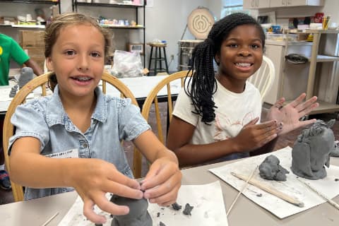 girls working with clay