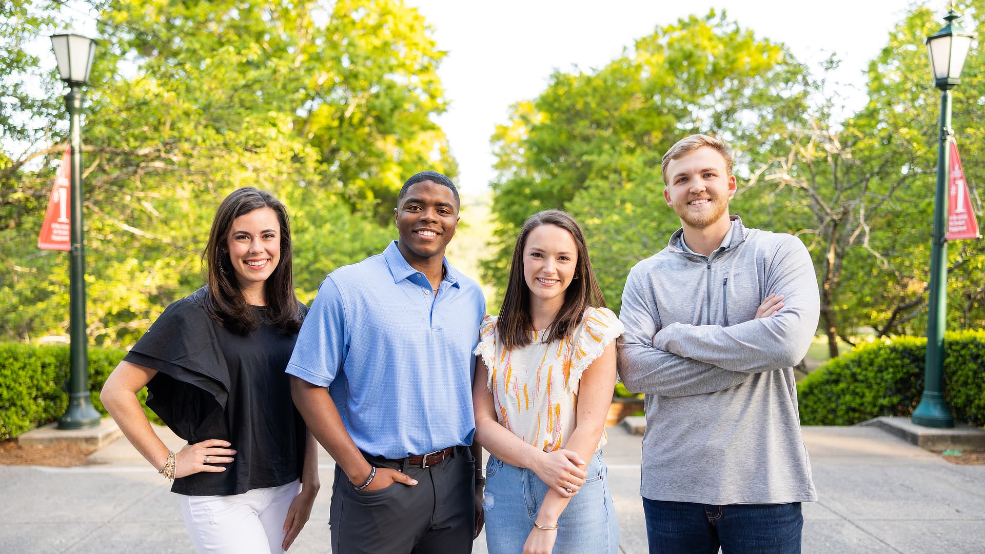 Four smiling grad students