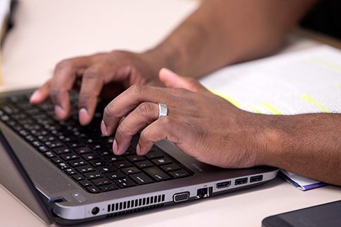 hand typing on keyboard