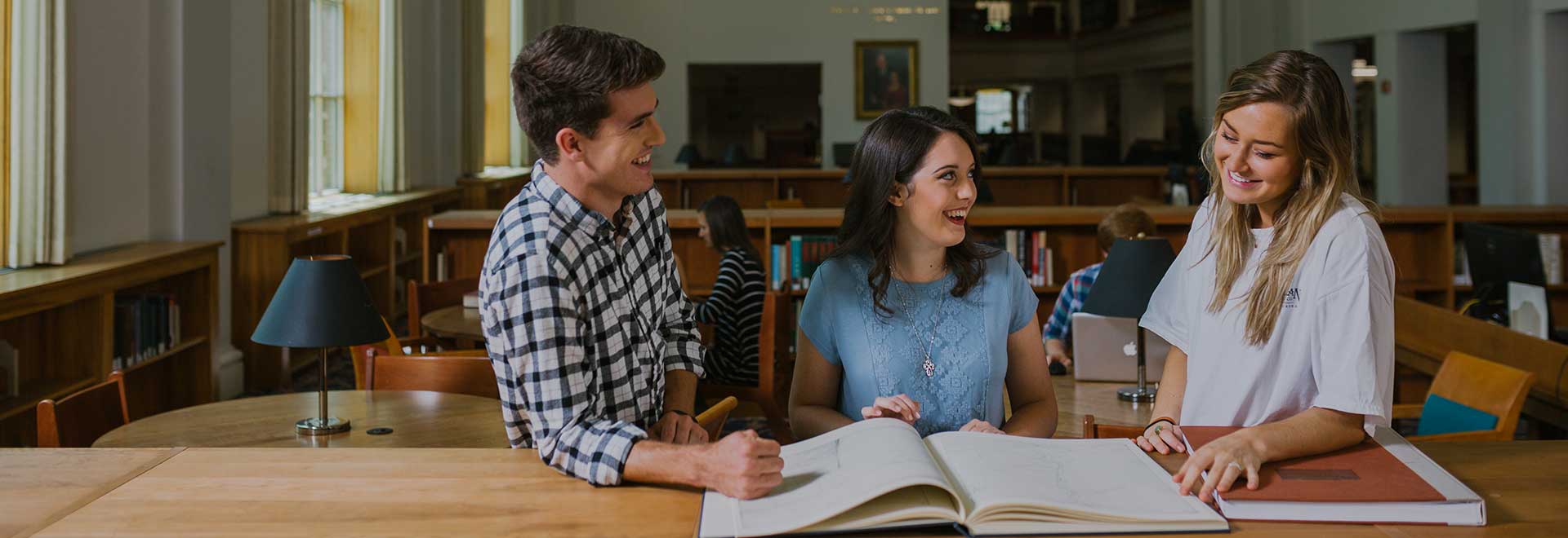 students laughing in library