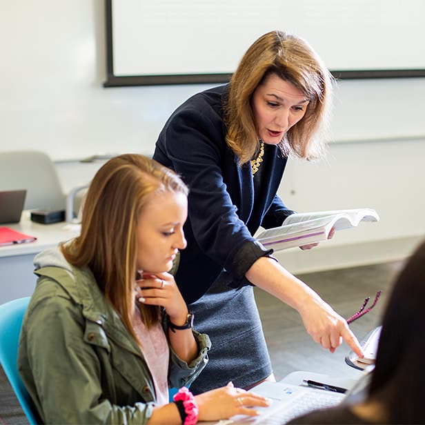 Female professor instructing female student