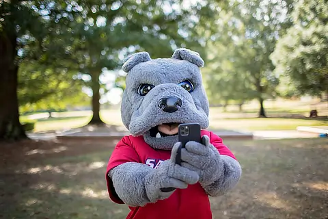 Sam the mascot with cellphone DR10132022880
