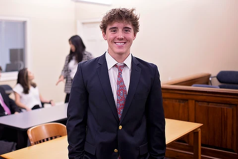 Male Student Taking Picture In Classroom