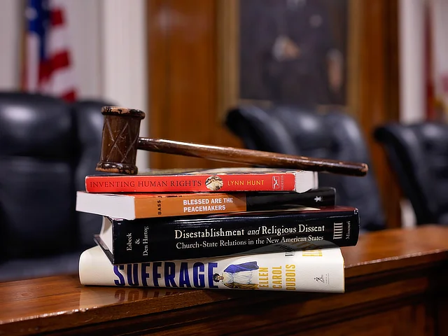 Pile of books with gavel on top