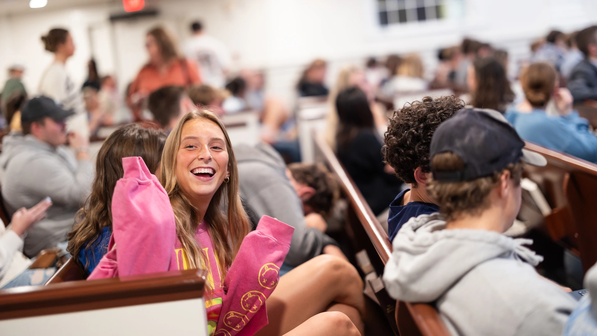 femlae studnet waving in chapel SC10242023641