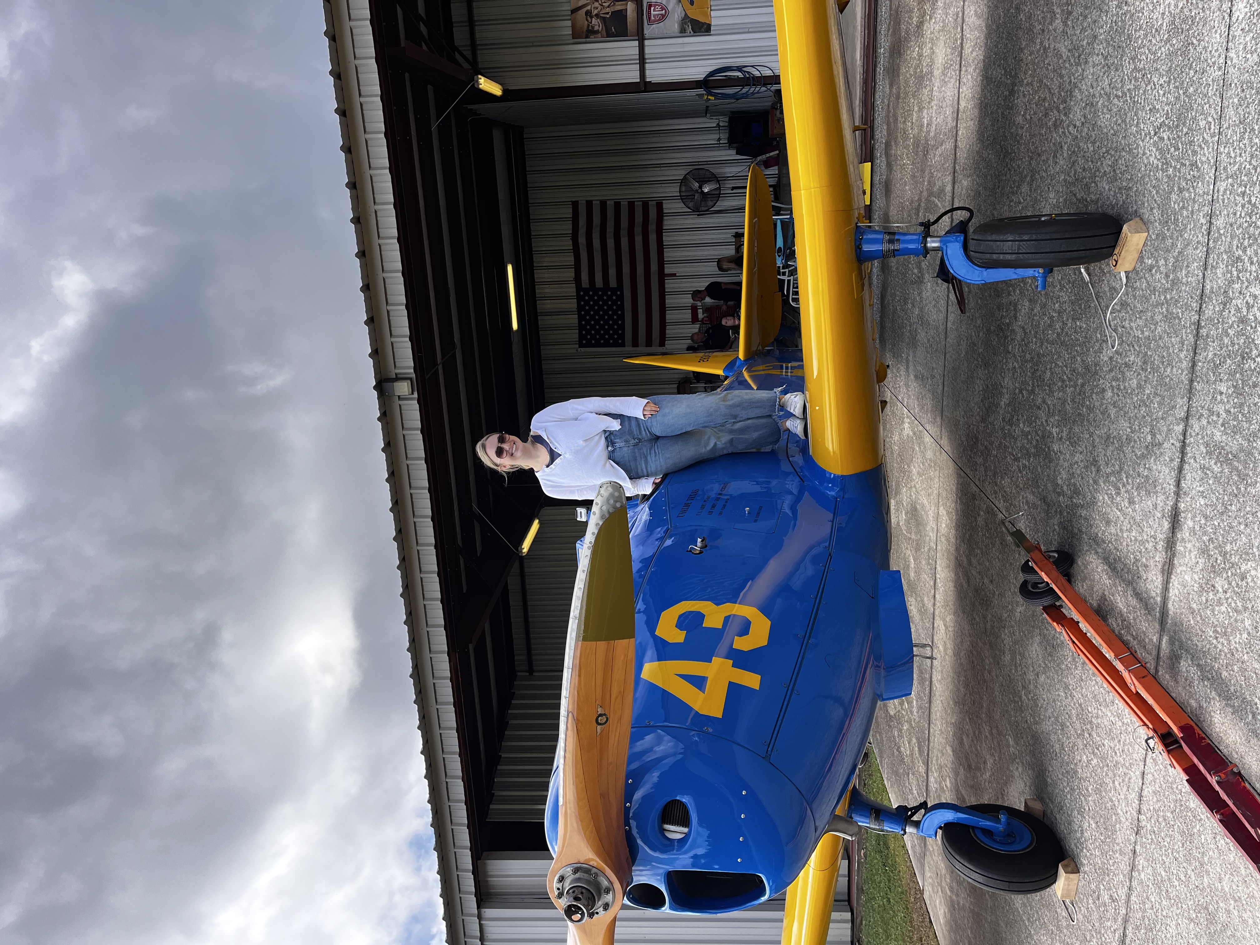 Journalism and mass communications major Karlie Rosenberry next to a WWII PT-19A aircraft. (Photograph Courtesy: Karlie Rosenberry) 
