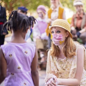 young woman talking to child