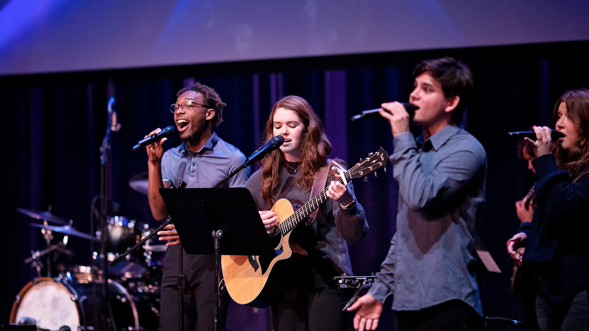 Three Music Students Singing onStage