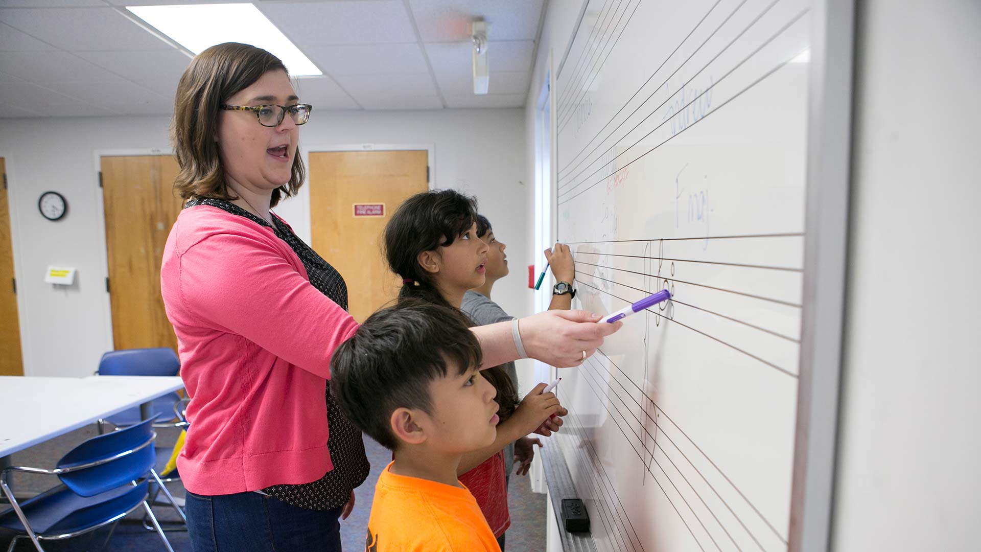 female teacher instructing young musicians