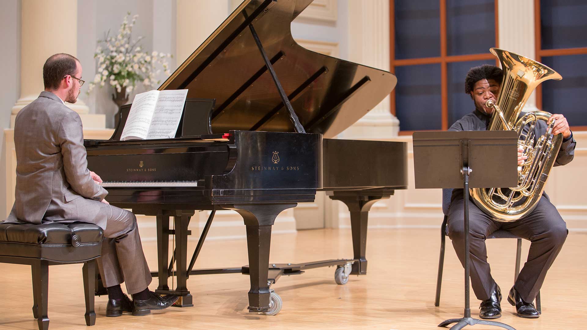 two male students playing piano and tuba in honors recital