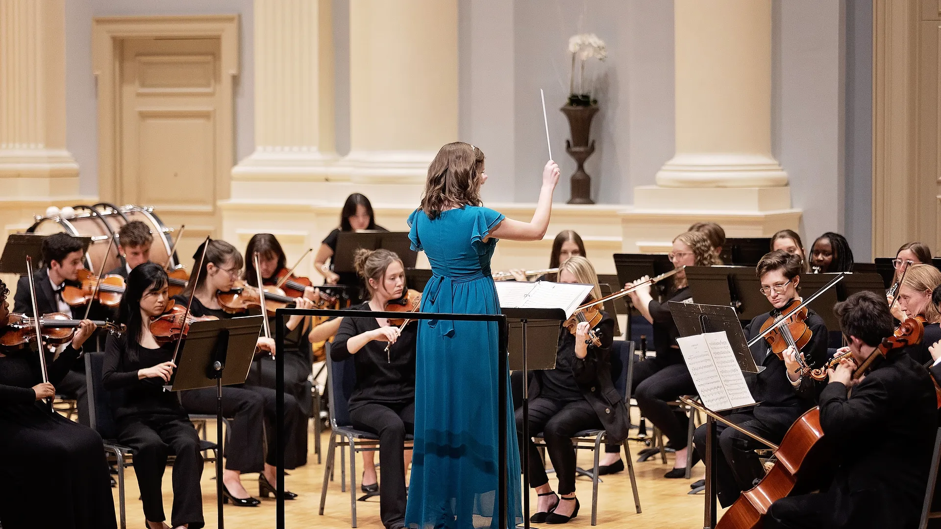 female teacher directing the orchestra