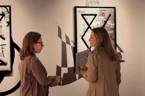 two students discussing art