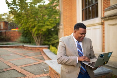 black male student with laptop