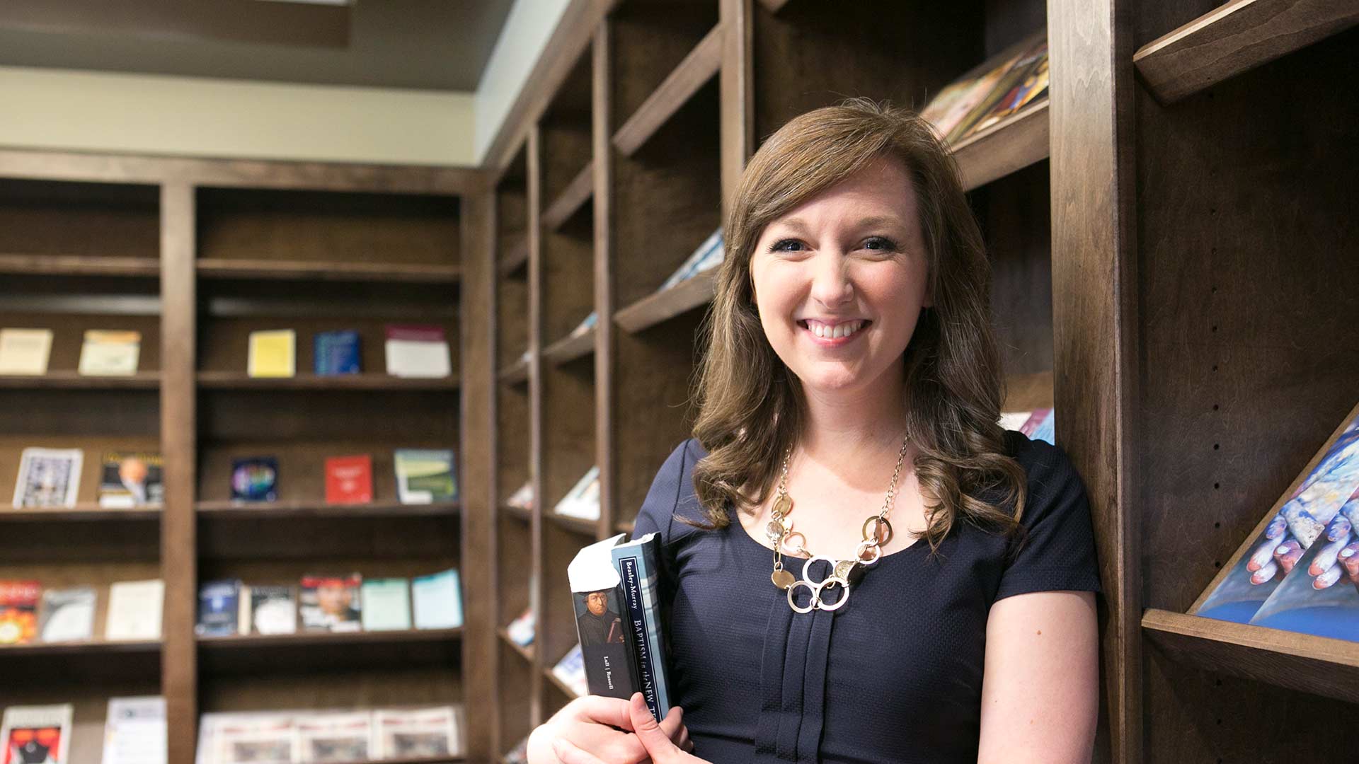 female student by magazine racks