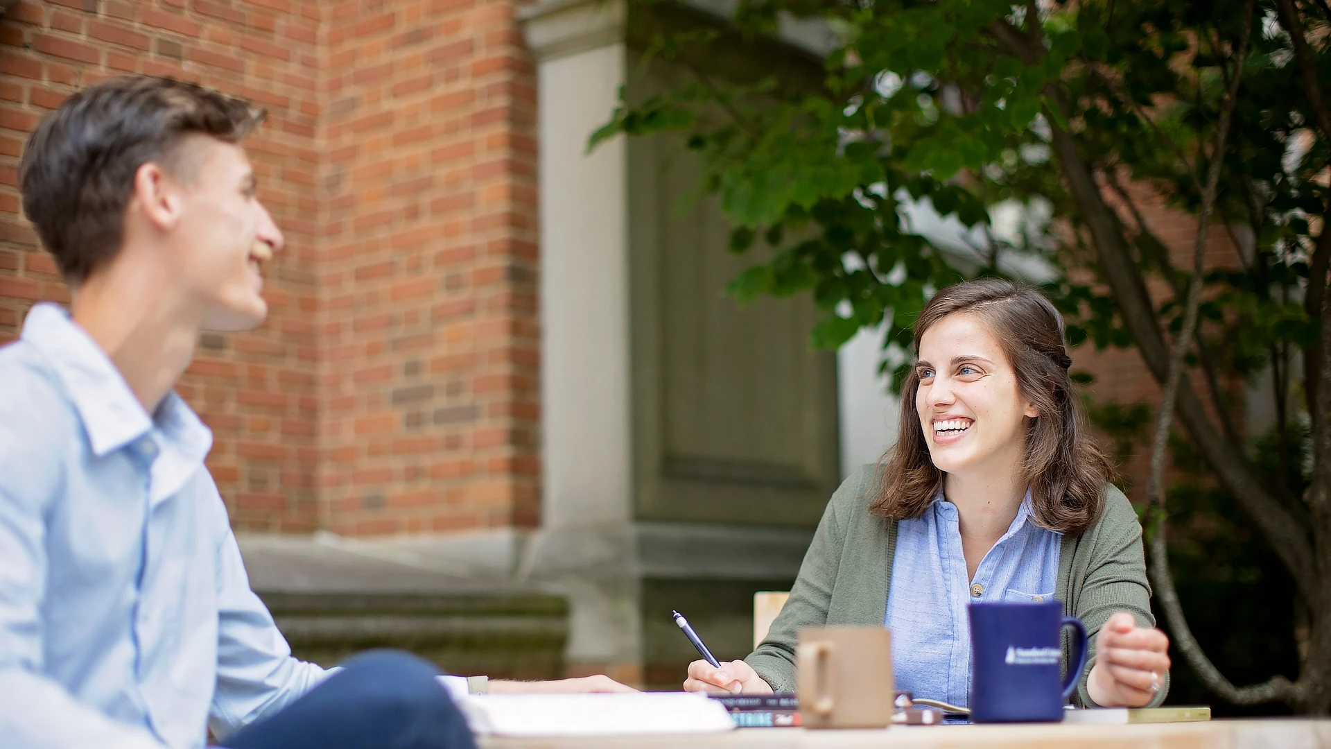 two students studying outside