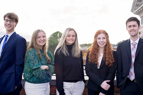 five business students standing together