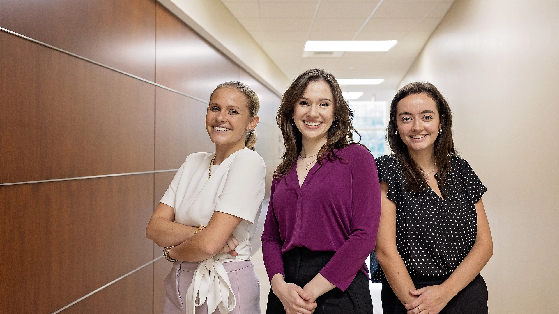 3 smiling female business students