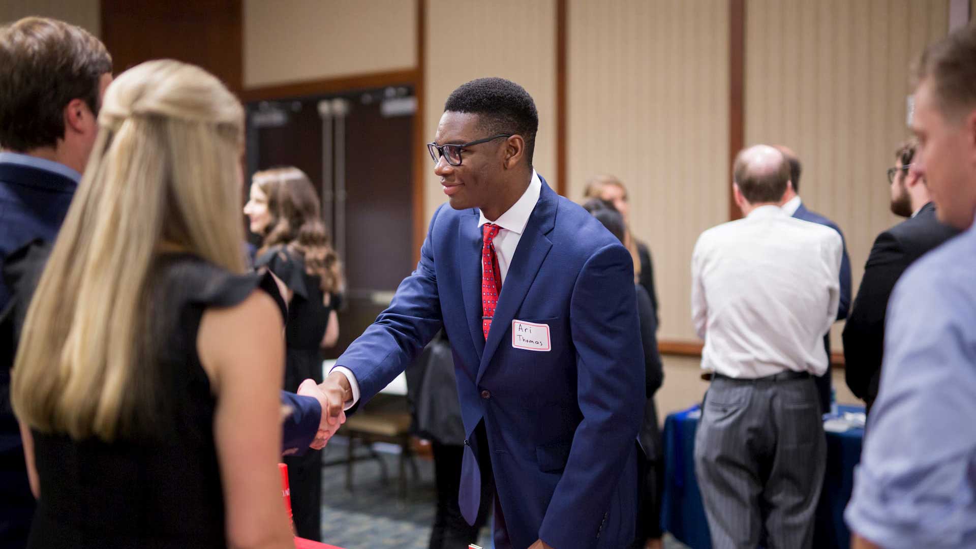 business student shaking hands at event