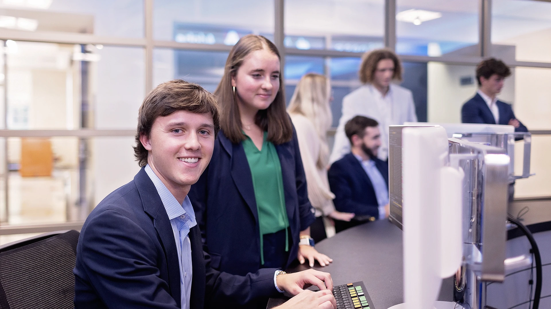 two business students working a computer