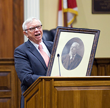 Professor Walthall holds a picture of former Law Dean Green.