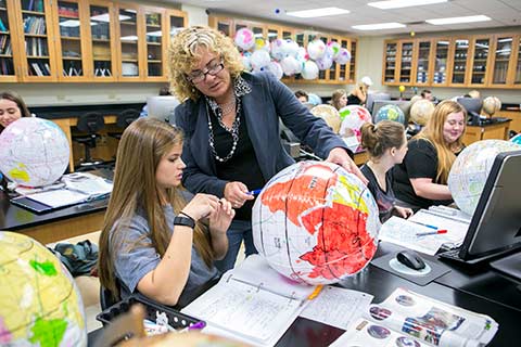 teacher in geography classroom