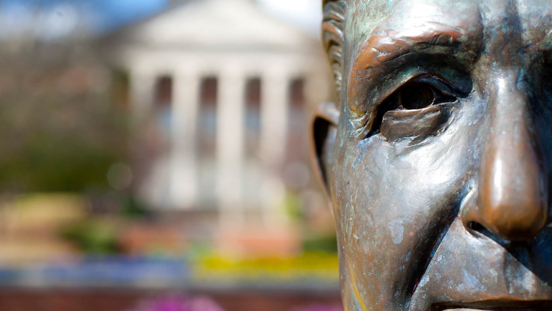 closeup of beeson statue with library in background