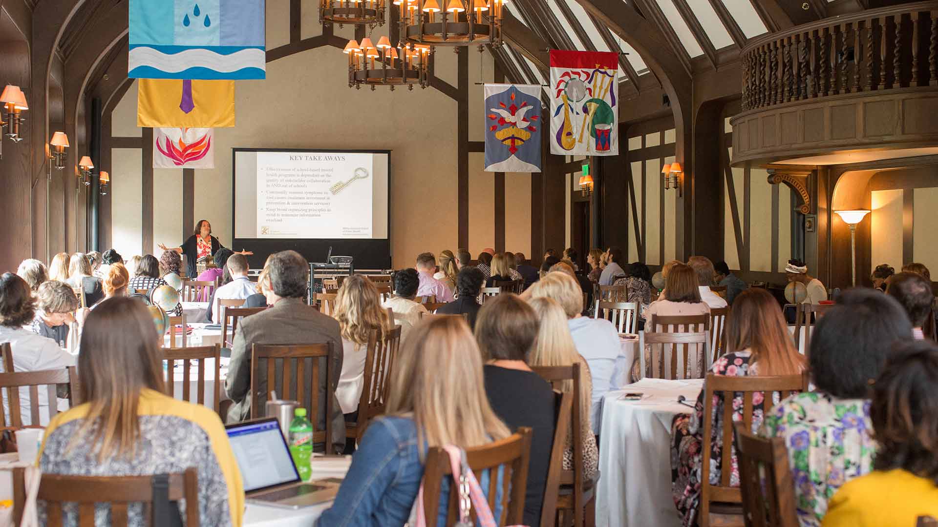 group listening to speaker at conference