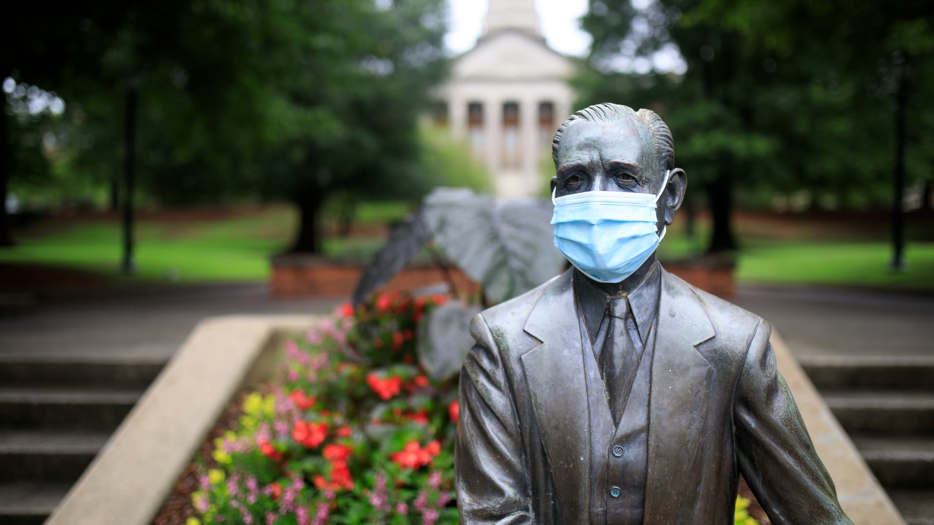 Mr. Beeson statue wearing a mask