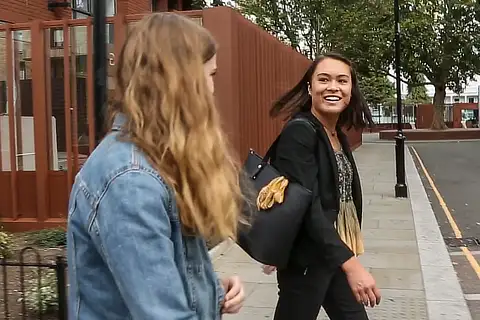 Two Female Students Walking Outside