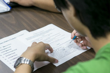 male student filling out form