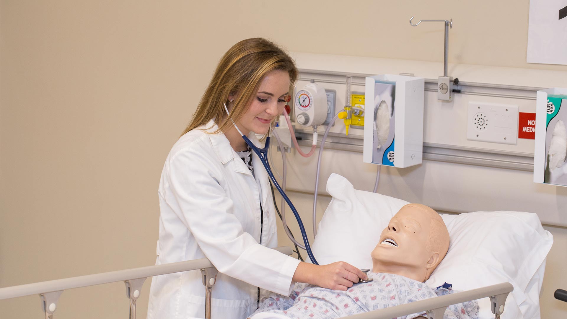 physician assistant using stethoscope