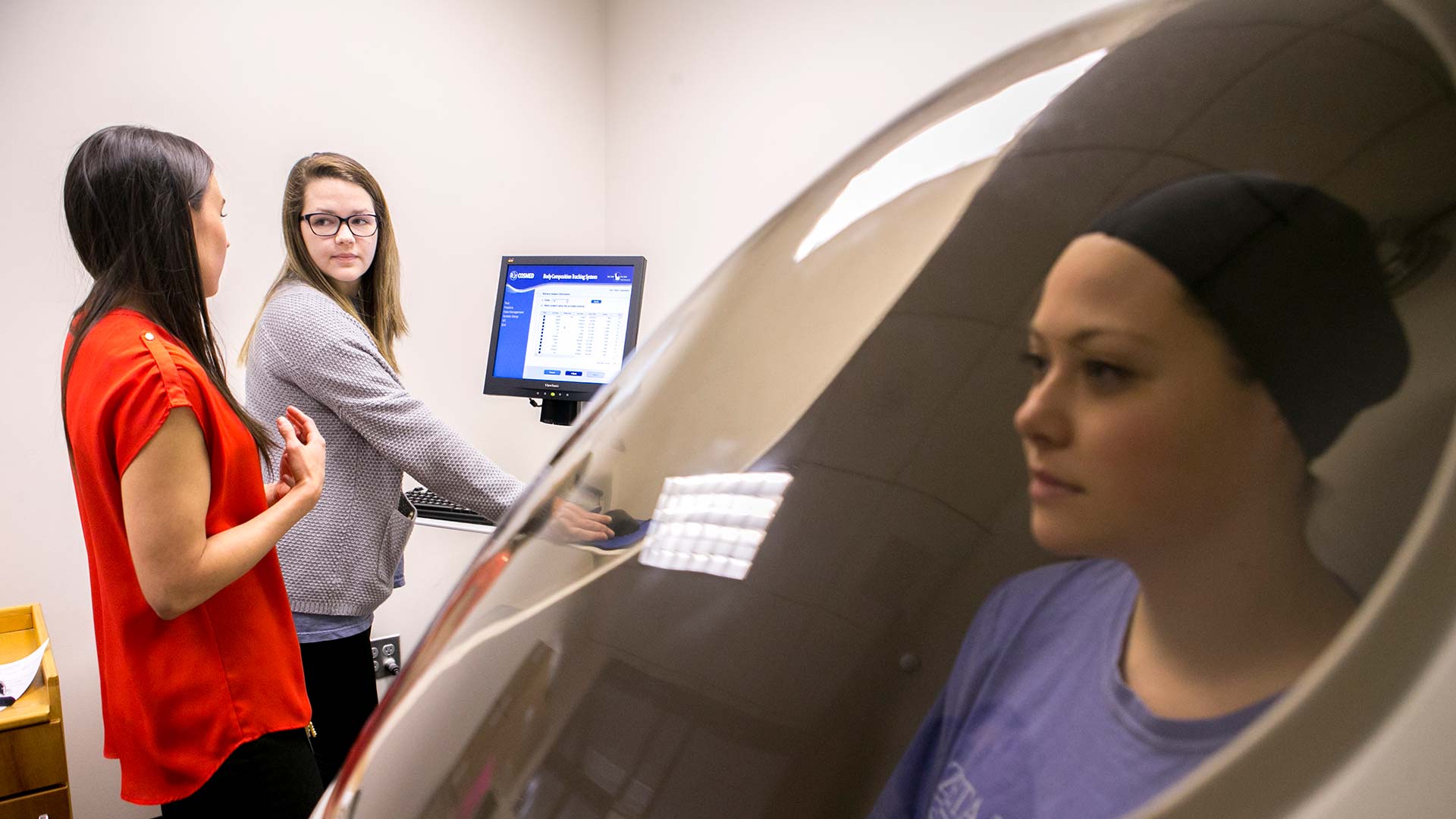 student in pod with two students observing