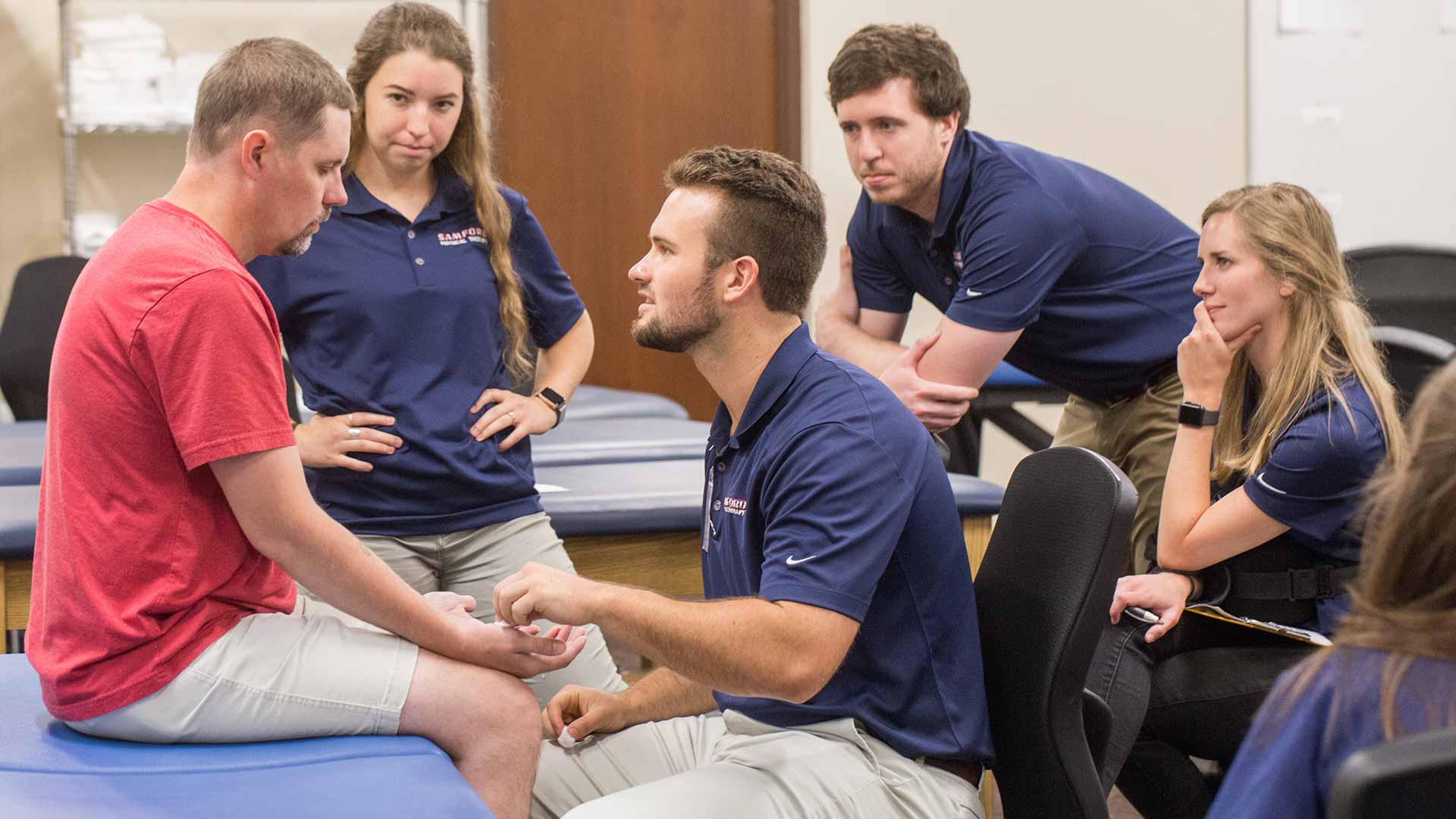 physical therapy students testing head injured man