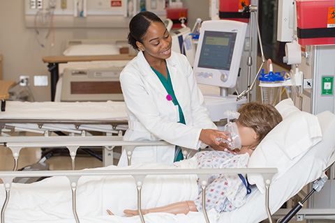 student in hospital lab