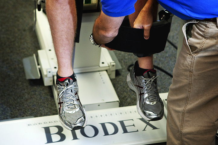 student and professor using kinesiology equipment