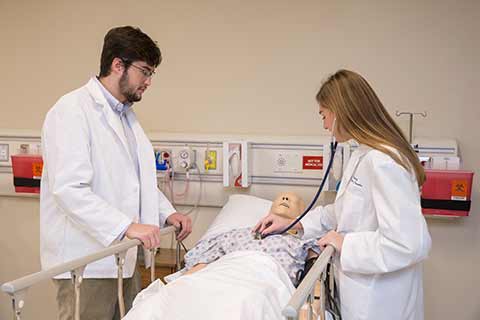 students checking on a patient