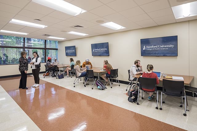 A professor teaches a class in the Active Learning Lab