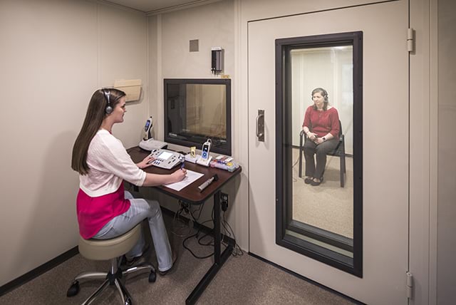 A student conducts a hearing test on a patient in Samford's Audiology booth