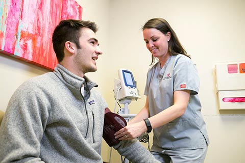 nurse taking student blood pressure