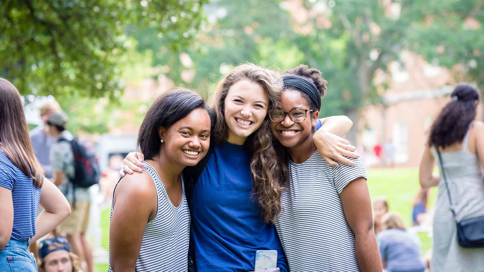 three female students hugging