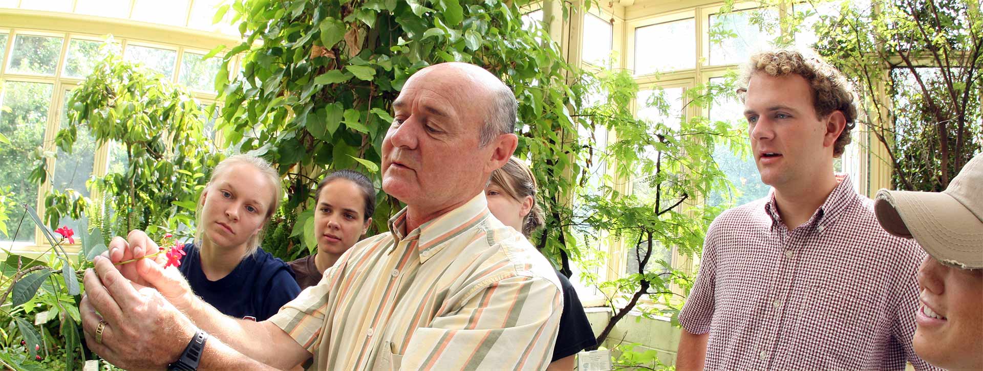 Davenport in Conservatory with Students Header