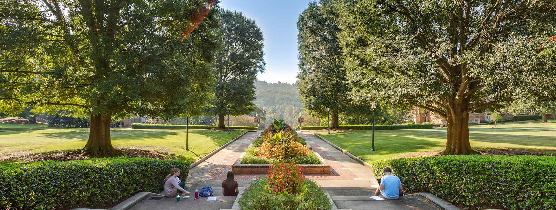 Students Walking in Front of the Library Header