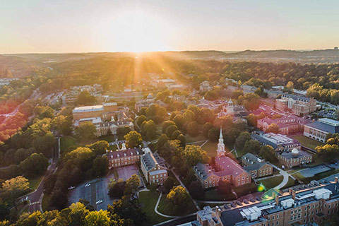 drone view of campus toward setting sun