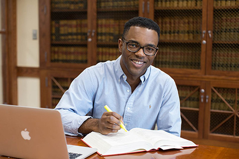 male student highlighting textbook CTA