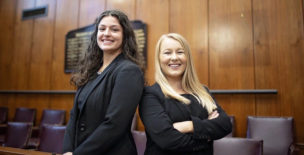 Two Female Law Students Standing Back to Back2