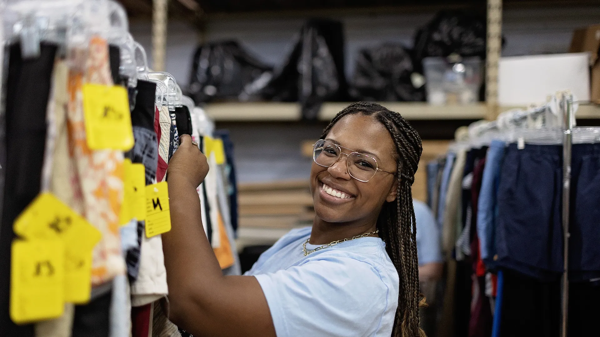 female law student helping with clothes rack
