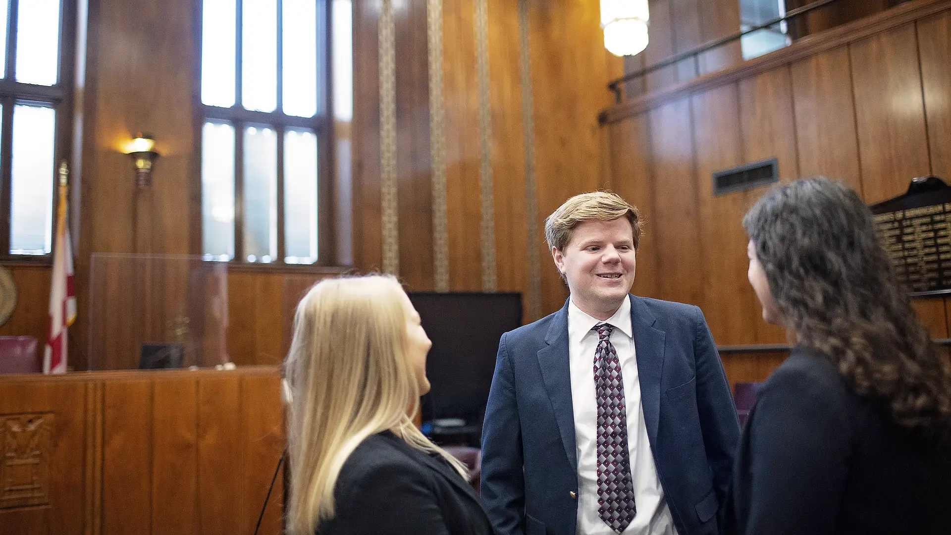 three law stuents in a court room