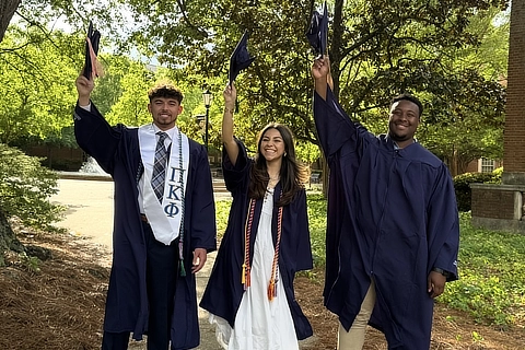 3 graduates celebrating